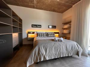 a bedroom with a bed with two shoes on it at Rentarte in Pilar