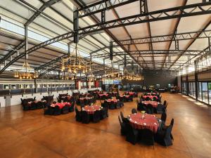 a large hall with tables and chairs and chandeliers at Safari Hotel & Convention Centre in Rustenburg