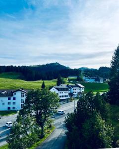 a view of a town with houses and a street at Haus Alpina - CharmingStay in Flumserberg