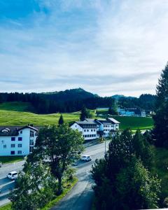 a view of a town with houses and a street at Haus Alpina - CharmingStay in Flumserberg +5 photos