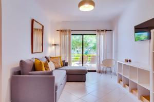 a living room with a couch and a table at Apartamentos Sol Nascente 2 in Vilamoura