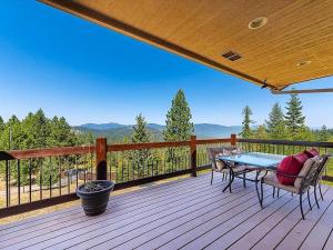 a patio with a table and chairs on a deck at Cozy Home w/ Views from Heaven! in Spokane