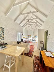 a living room with a table and a couch at The Annex in Pringle Bay +8 photos