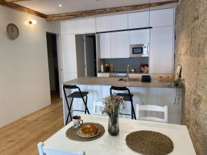 a table with a plate of food on it in a kitchen at Apartamento HALO VIGO in Vigo