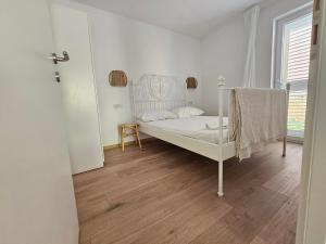 a bedroom with a white bed and a wooden floor at Vila Regina Apartment Rex with Swimming Pool in Jezera +178 photos