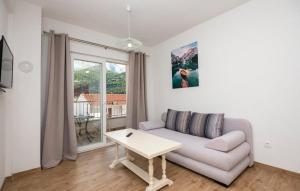 a living room with a couch and a table at Apartmani Valentina Drvenik in Drvenik