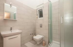 a bathroom with a toilet and a sink and a shower at Apartmani Valentina Drvenik in Drvenik +31 photos