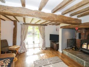 a living room with a couch and a fireplace at Millstone House in Lutterworth