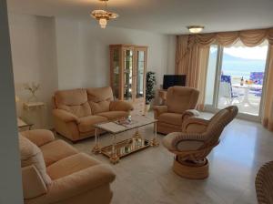 a living room with a couch and chairs and a table at Panorama3 in Altea la Vieja