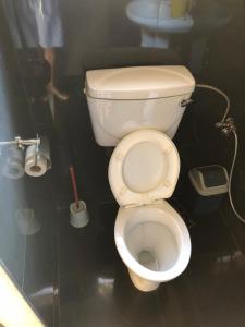 a bathroom with a white toilet in a stall at Residencial Meu Tio in Chimoio