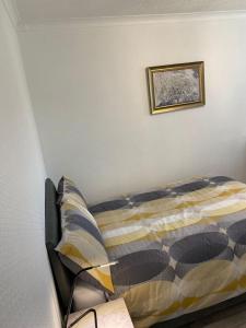 a bed in a bedroom with a picture on the wall at Spacious Three Bedroom Bungalow in Kirkham