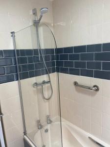 a bathroom with a shower and a bathtub with a glass door at Spacious Three Bedroom Bungalow in Kirkham