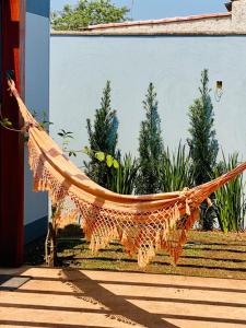 a hammock is hanging in front of a building at Bangalô Miraflores in Chapada dos Guimarães