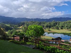 a view of a lake from a fence at Beautiful Lake View Villa. Lake Access & Near Town in Guatapé