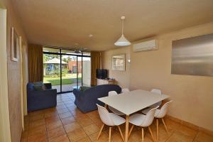 a living room with a white table and chairs at Riverview Holiday Apartment 47 - Kalbarri, WA in Kalbarri