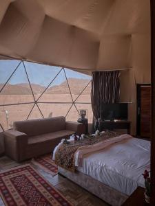 a bedroom with a bed and a view of the desert at Scoop Rum in Wadi Rum