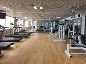 a gym with a row of treadmills and machines at סטודיו על הים in Bat Yam