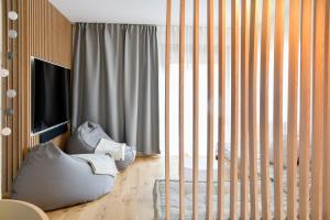 a room with a crib and a large window at Rock Garden Apartment in Arco