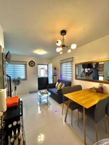 a living room with a couch and a table at Two-Bedroom Townhouse Camella Bacolod South in Bacolod