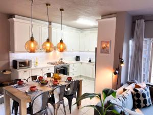 a kitchen and dining room with a table and chairs at Seaside Stay - Beachfront/ Backup Inverter/ Housekeeping in Ballito