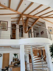 a room with a spiral staircase in a house at Luxus-Loft Atrium -X- in Rorbas