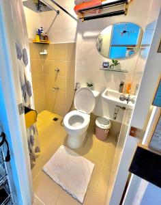 a small bathroom with a toilet and a sink at Two-Bedroom Townhouse Camella Bacolod South in Bacolod