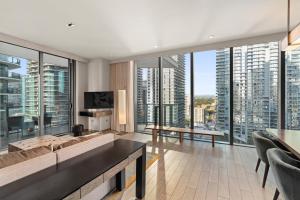 a living room with a couch and large windows at EAST Miami in Miami