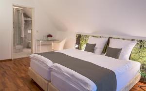 a bedroom with a large bed with white pillows at Eurostrand Resort Lüneburger Heide in Fintel +20 photos