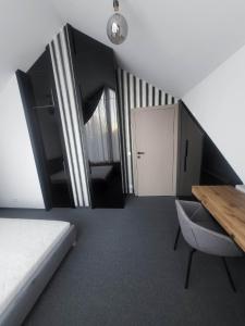 a room with a bed and a table and a door at Luksusowy apartament 55 m, Nowy in Krakow