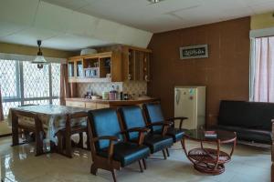 a living room with a table and chairs at Villa solomio in Tawangmangu