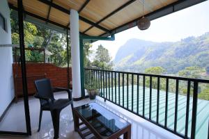 a balcony with a view of the mountains at Rock side inn - Ella in Ella