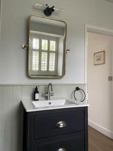 a bathroom with a sink and a mirror at Holly Bank in Longborough