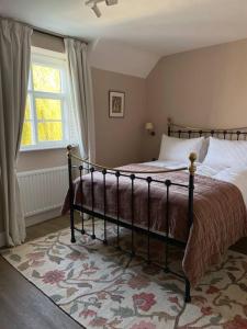 a bedroom with a bed and a window at Holly Bank in Longborough