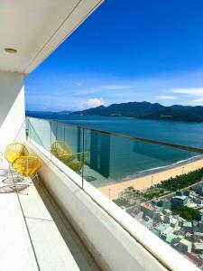 a balcony with two chairs and a view of the beach at TMS Apartment View Biển Luxury Quy Nhơn in Quy Nhon +115 photos