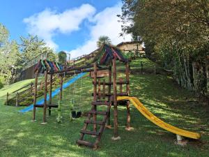 a playground with a ladder and a slide at Beautiful Lake View Villa. Lake Access & Near Town in Guatapé
