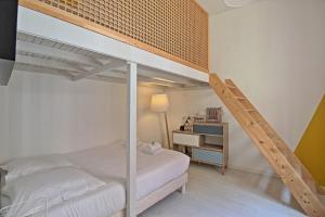 a bedroom with a bunk bed and a ladder at Le Sensas - Climatisation et Centre in Nîmes