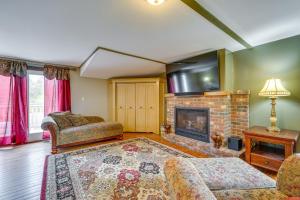 a living room with a fireplace and a tv at Buskirk Vacation Rental with Deck and Putting Green! 