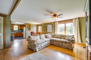 a living room with a couch and a kitchen at Buskirk Vacation Rental with Deck and Putting Green! 