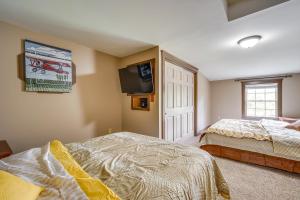a bedroom with two beds and a tv on the wall at Buskirk Vacation Rental with Deck and Putting Green! 