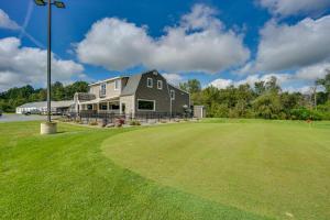 a house on a golf course with a green field at Buskirk Vacation Rental with Deck and Putting Green! in Buskirk
