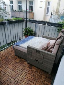 a bed sitting on top of a balcony at Luxury near Castle in Vienna