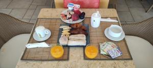 a table with a tray of breakfast food on it at Hôtel & Spa La Villa in Sainte-Maxime