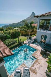 a swimming pool with two people in a house at The Cape Bali in Cape Town
