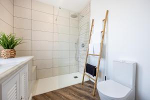 a bathroom with a toilet and a shower at Angra Charming Suites by Seewest in Angra do Heroísmo