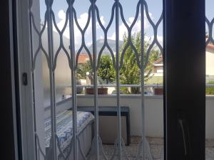 a window with a view of a balcony with a table at Chambre privative avec terrasse X in Saint-Martin-dʼHères