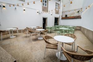a room with tables and chairs and lights at HOTEL CORONA DE PADRÓN in Padrón