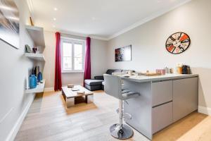 a kitchen and living room with a desk and a couch at Vatican Guest House in Rome