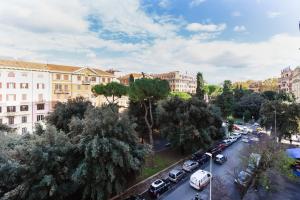 a city street with cars parked in a parking lot at Vatican Guest House in Rome