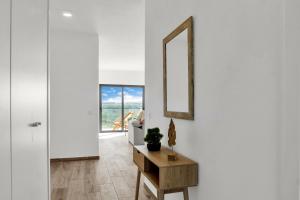 a living room with a mirror and a table at Apartamento Campo e praia in Aljezur
