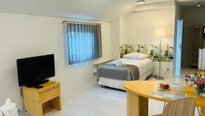 a bedroom with a bed and a table with a television at AZYL in Legnica